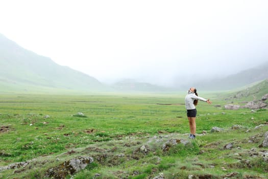 Happy hiker in the mountain celebrating vacation