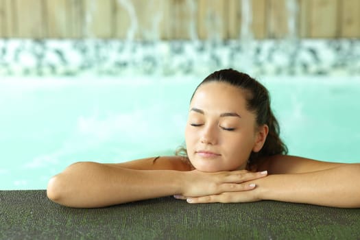 Beautiful woman resting in a spa pool