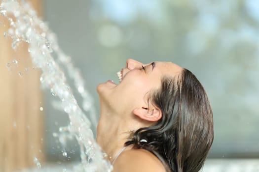 Woman laughing enjoying under water jet in spa pool