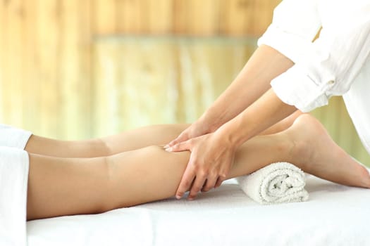 Close up of a woman legs receiving a massage in spa