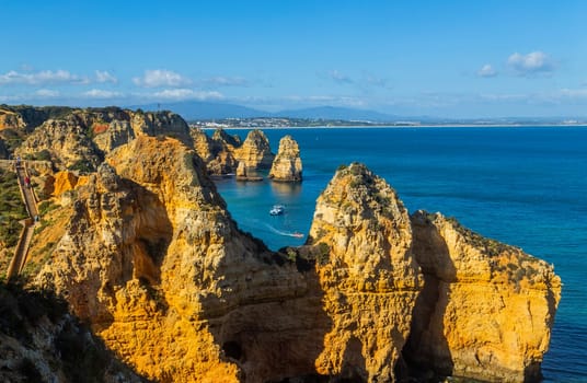 Lagos, Portugal - 5 April 2022: Tourists visiting Ponta da Piedade near Lagos, Algarve, Portugal