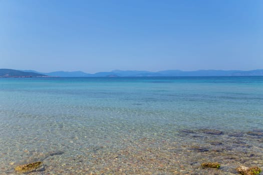 The coast of Aegina island with clear and blue waters of Mediterranean sea in the Saronic gulf, Greece.