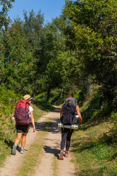 Navarre, Spain, 26 August, 2022: Pilgrims walk along the Camino De Santiago, the Way of St. James pilgrimage route, Navarra, Spain.