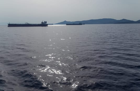 Athens, Greece: 6 May, 2022 - Merchant vessels and cargo container ships outside the Pireus port. Greece