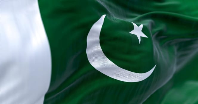 Detail of of Pakistan National flag waving. Green with white band on hoist  white crescent moon and five-pointed star. 3d illustration render. Selective focus. Close-up. Textured background