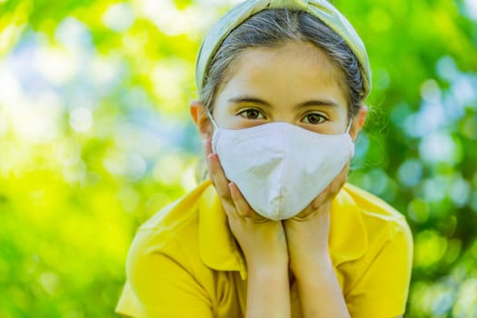 Little girl with mask against corona virus covid outdoor