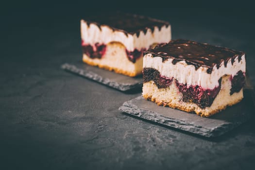 German cake Donauwelle (Danube waves) - vanilla and chocolate sponge cake with sour cherries, vanilla buttercream and chocolate icing