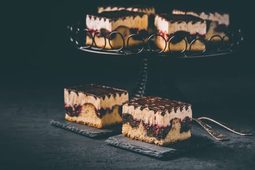 German cake Donauwelle (Danube waves) - vanilla and chocolate sponge cake with sour cherries, vanilla buttercream and chocolate icing