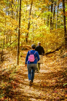 Senior couple is hiking in the woods in North Carolina in fall