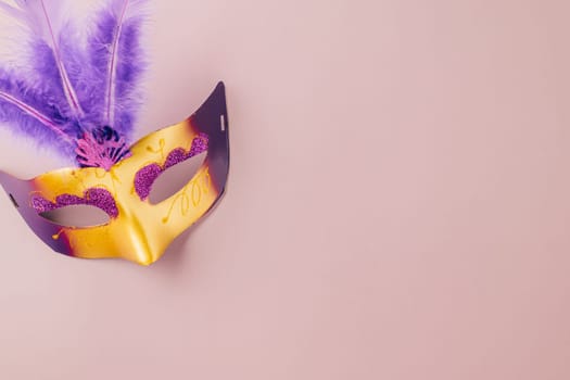 Happy Purim carnival. Carnival mask for Mardi Gras celebration isolated on purple background banner design with copy space, jewish holiday, Purim in Hebrew holiday carnival ball, Venetian mask