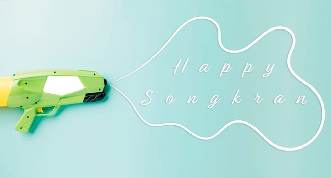 Happy songkran day festival at Thailand. water gun shoot water splash drawing empty space for text isolated on pastel blue background, traditional Thai New Year, Web banner design