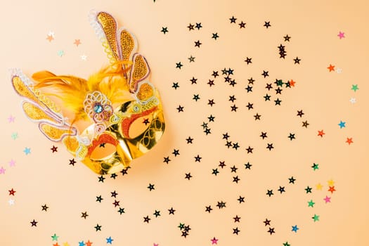 Happy Purim carnival decoration. Purim and Mardi Gras in Hebrew, Masquerade party event, celebration background banner design, Golden venetian ball mask, carnival mask isolated on pastel background