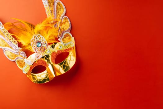 Happy Purim carnival. Carnival mask for Mardi Gras celebration isolated on red background banner design with copy space, jewish holiday, Purim in Hebrew holiday carnival ball, Venetian mask