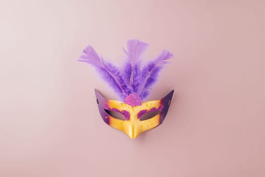 Happy Purim carnival. Carnival mask for Mardi Gras celebration isolated on purple background banner design with copy space, jewish holiday, Purim in Hebrew holiday carnival ball, Venetian mask