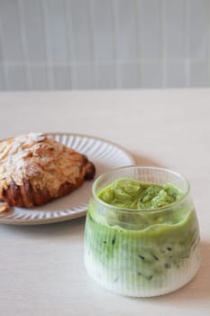 ce matcha green tea served with croissant, stock photo