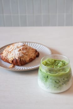 ce matcha green tea served with croissant, stock photo
