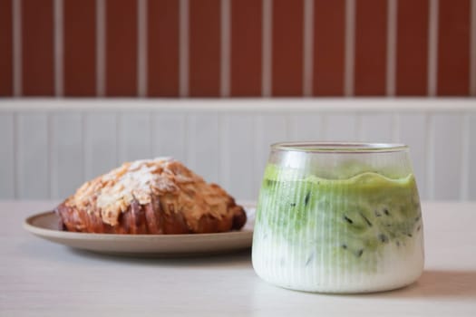 ce matcha green tea served with croissant, stock photo