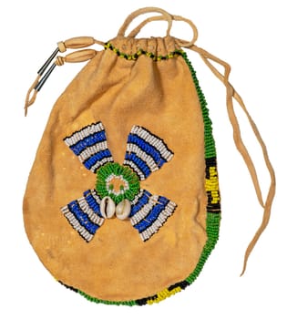 Bag of the North American Indians. Made from deerskin embroidered with colorful glass beads and leather cords isolated on white