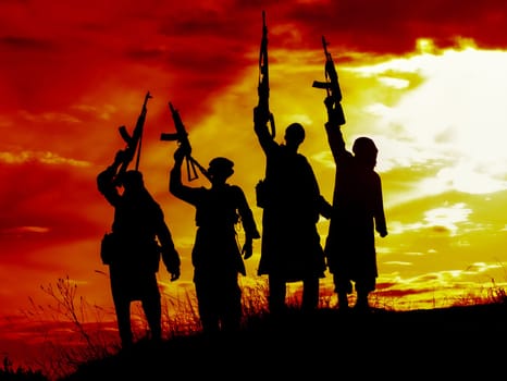 Silhouette of several muslim militants with rifles