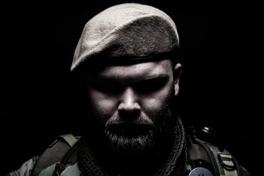Close up portrait of bearded commando fighter, army special forces soldier, private military company mercenary wearing beret. Pride and tradition of military service, elite or special forces unit