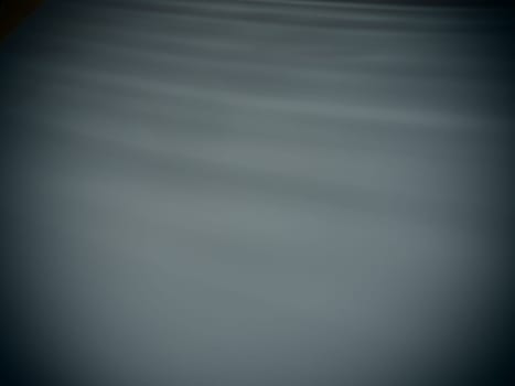 Diagonal rays of light on a gray background. Blurred abstract background light effect, light leaks. Side surface illumination. Small sparks and glow. Shine, glint or glare.
