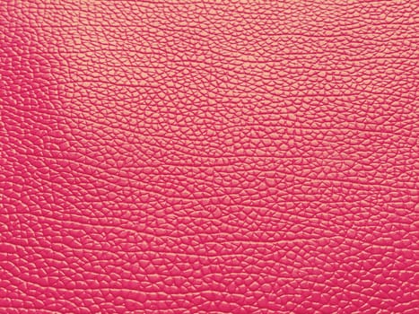 Faux leather scarlet. Separate grooves and elevations on the surface of a bag or shoe. Reflection of the light. Fashion accessory made of faux pig skin. Close-up.