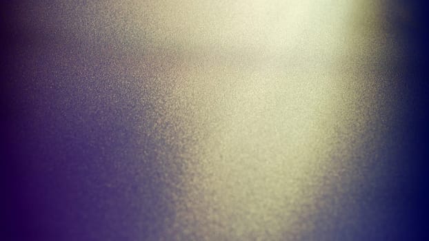 Oblique rays of light on a dark background. Blurred abstract backdrop with light effect and leaks. Side surface illumination. Divergent and asymmetric lines, stripes of light at angle. Yellowish glow.