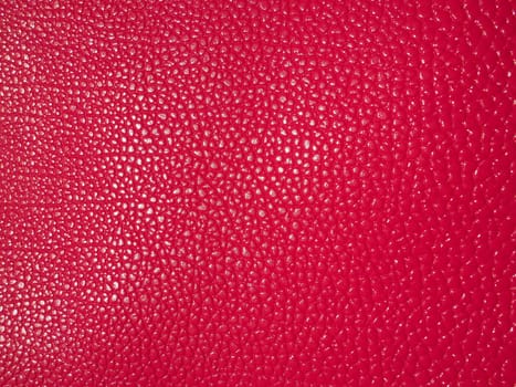 Red or pink leather. Material for fashion accessories, for sewing leather and suede products, furniture upholstery. Natural leather texture. Magenta or fuchsia