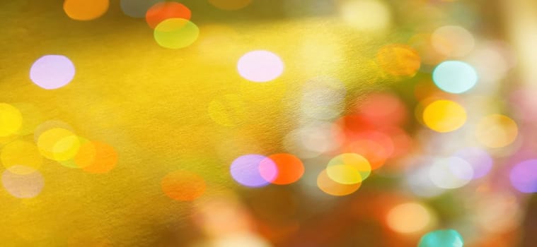 Festive warm background or greeting card. Sun glare on a bright yellow background. The nuances of orange, yellow, pink, lilac, beige and white. Beautiful bokeh effect.