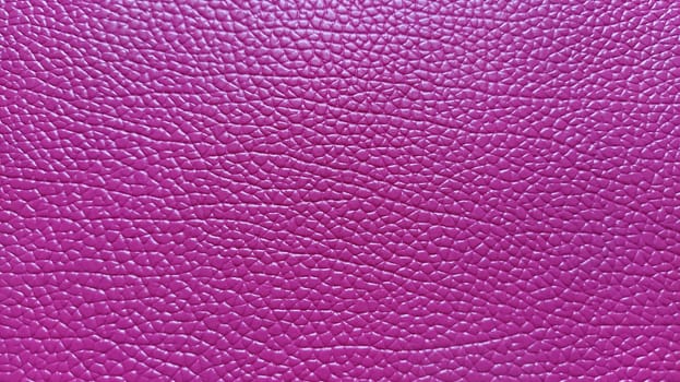 Artificial leather is bright pink or fuchsia. Distinct furrows and elevations on the surface of a bag or shoe. Reflection of the light. Fashion accessory made of imitation pig skin. Close-up.