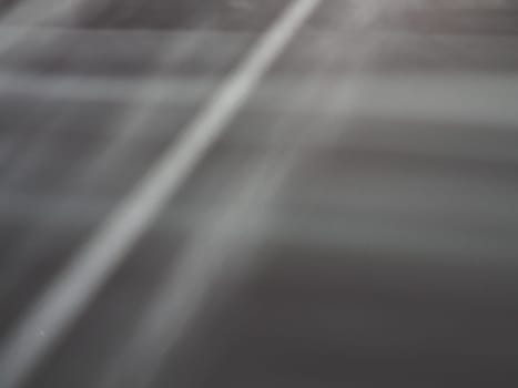 Illumination rays on gray surface. Abstract rays of light and lens flare on a gray background. Vertical, horizontal and diagonal light stripes.