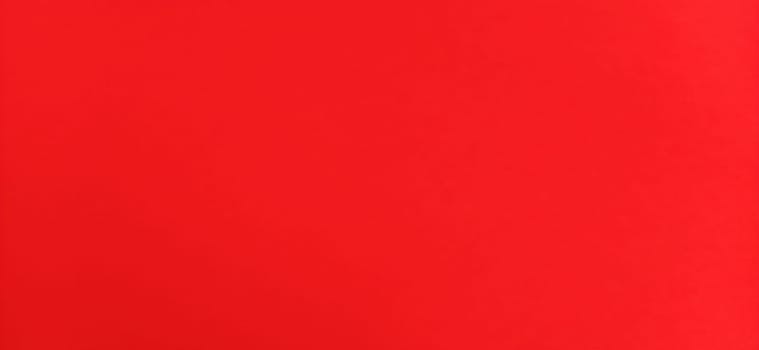 Red beautiful bright background. Scarlet uneven color. Sheet of colored paper.
