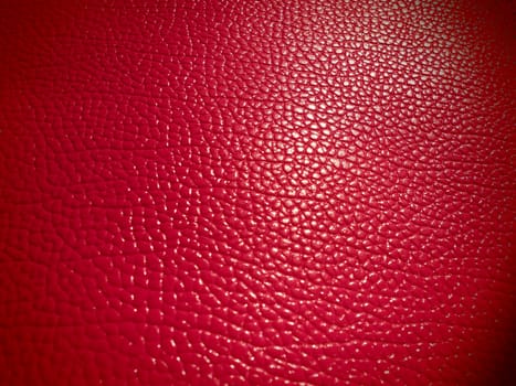 Red or pink leather. Material for fashion accessories, for sewing leather and suede products, furniture upholstery. Natural leather texture. Magenta or fuchsia.