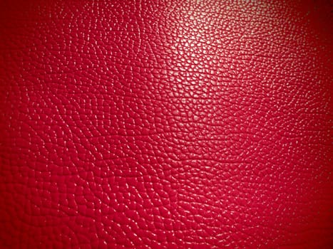 Red or pink leather. Material for fashion accessories, for sewing leather and suede products, furniture upholstery. Natural leather texture. Magenta or fuchsia.