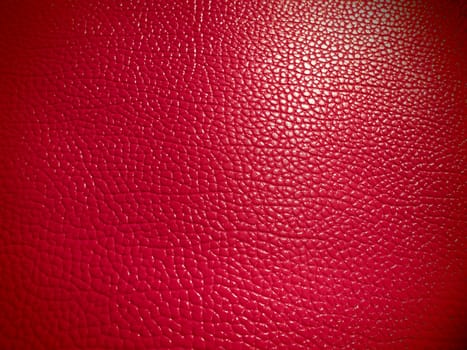 Red or pink leather. Material for fashion accessories, for sewing leather and suede products, furniture upholstery. Natural leather texture. Magenta or fuchsia.