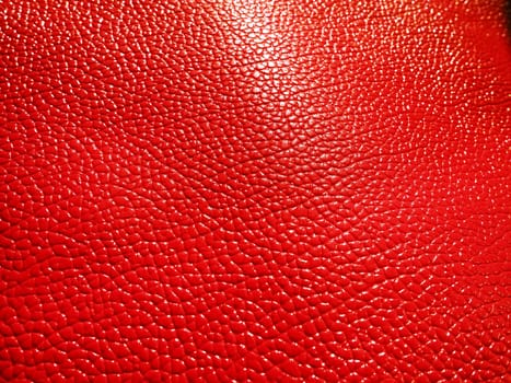 Red or pink leather. Material for fashion accessories, for sewing leather and suede products, furniture upholstery. Natural leather texture. Magenta or fuchsia