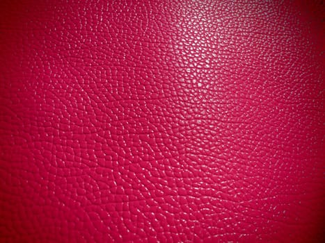Red or pink leather. Material for fashion accessories, for sewing leather and suede products, furniture upholstery. Natural leather texture. Magenta or fuchsia.