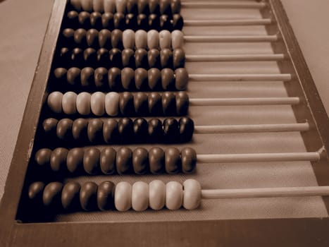 Education concept - abacus with many colorful beads. Red, blue, green, black, yellow details on the abacus. Mathematical exercises. School program.