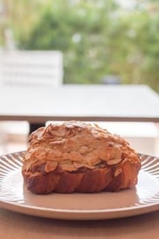 Freshly baked French croissant served in coffee shop, stock photo