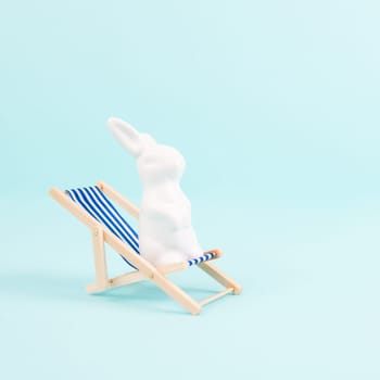 Bunny or rabbit sitting on lounge chair, easter holiday, vacation by the sea