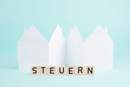 House with the german word for tax, planning to buy or build new home, real estate concept, owning property, taxation law