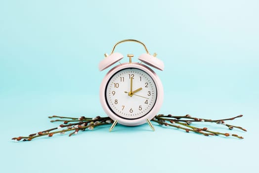 Alarm clock with pussy willow brances, switch to daylight saving time in spring, summer time changeover