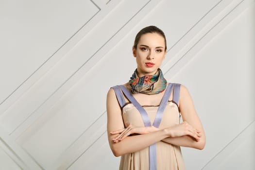Sensual woman with crossed hands and silk scarf on her neck