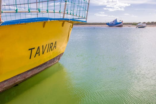 Traditional fishing boat docked at Cabanas de Tavira port, Portugal. Tavira word painted on side