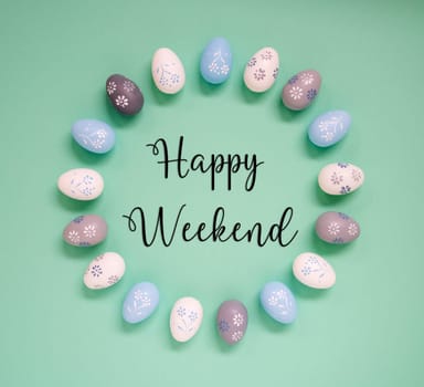 Flat Lay With English Text Happy Weekend. Easter Egg Arrangement, Decoration And Ornament. Light Green Paper Background
