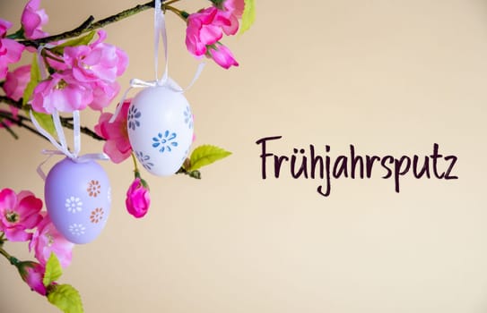 Beautiful Easter Egg Decoration With Spring Flowers. German Text Fruehjahrsputz Means Spring Cleaning. Seasonal Easter Holiday Greeting Card.