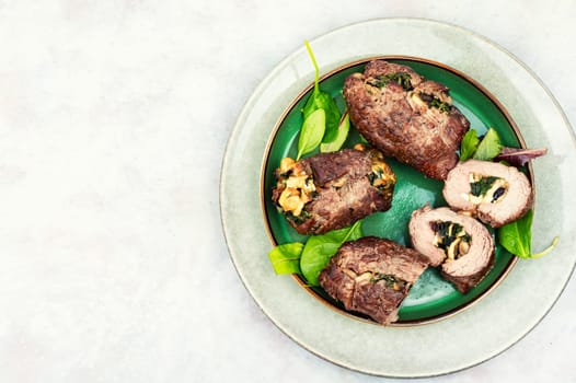 Beef meat rolls stuffed with mushrooms. Top view. Copy space