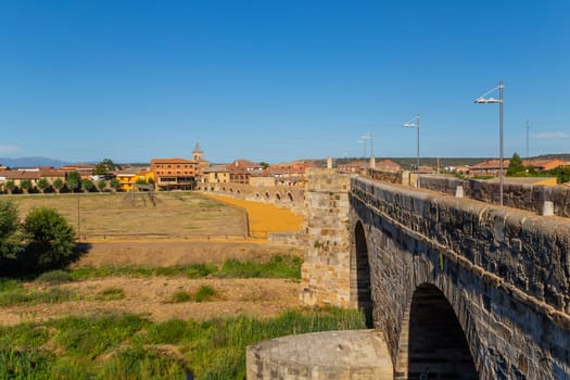 Hospital de Orbigo, Spain - August 18, 2022 - Some pilgrims walking along the way of St.James, in Hospital de Orbigo