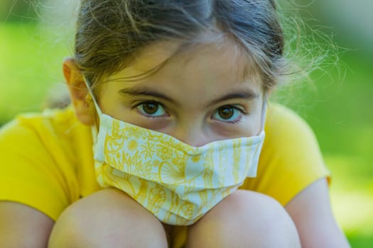 Little girl with mask against corona virus covid outdoor