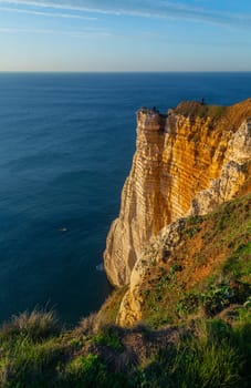 Etretat, France - November 11, 2022: People rest and enjoy the views of the coastal cliffs of the Alabaster Coast of Normandy. Etretat, France